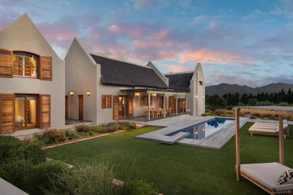 Private lap pool at Skaap Huis Lalapanzi Lodge with garden seating and mountain views.