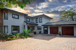 Exterior view of The First House showing its contemporary architecture, driveway and double garage.