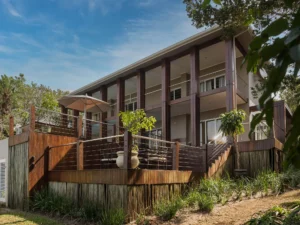 Exterior view of Villa Umdoni, a contemporary multi-storey villa with elevated decks, timber details and landscaped gardens.